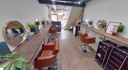 Trendy interior of Salon Pickle in Bromsgrove, England, showcasing elegant styling stations and decor.