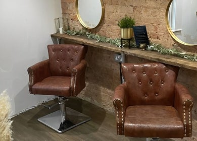 Elegant leather chairs and mirrors at Salon Pickle in Bromsgrove, England, GB.