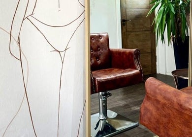 Leather chair and abstract art at Salon Pickle, Bromsgrove, England, GB, offering relaxing beauty services.