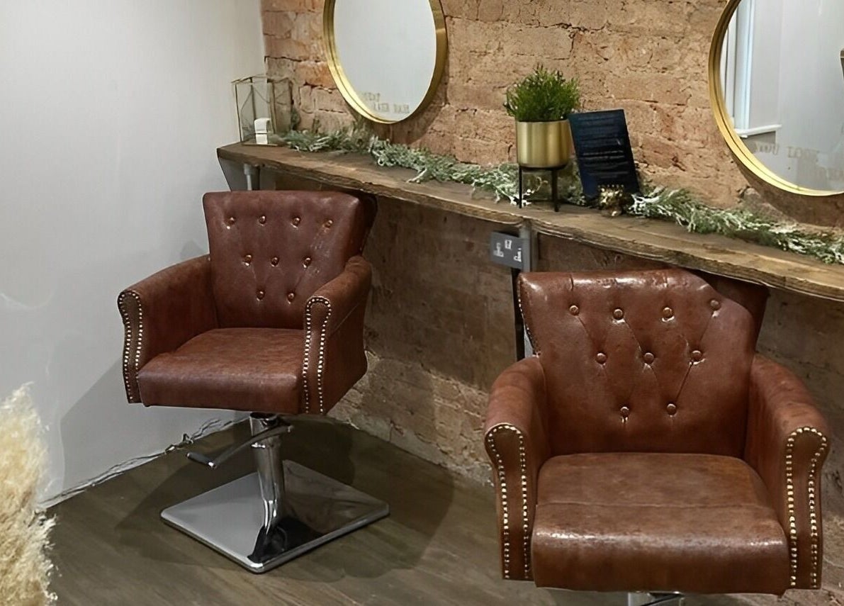 Elegant leather chairs at Salon Pickle in Bromsgrove, England, GB, offering a chic, vintage atmosphere.