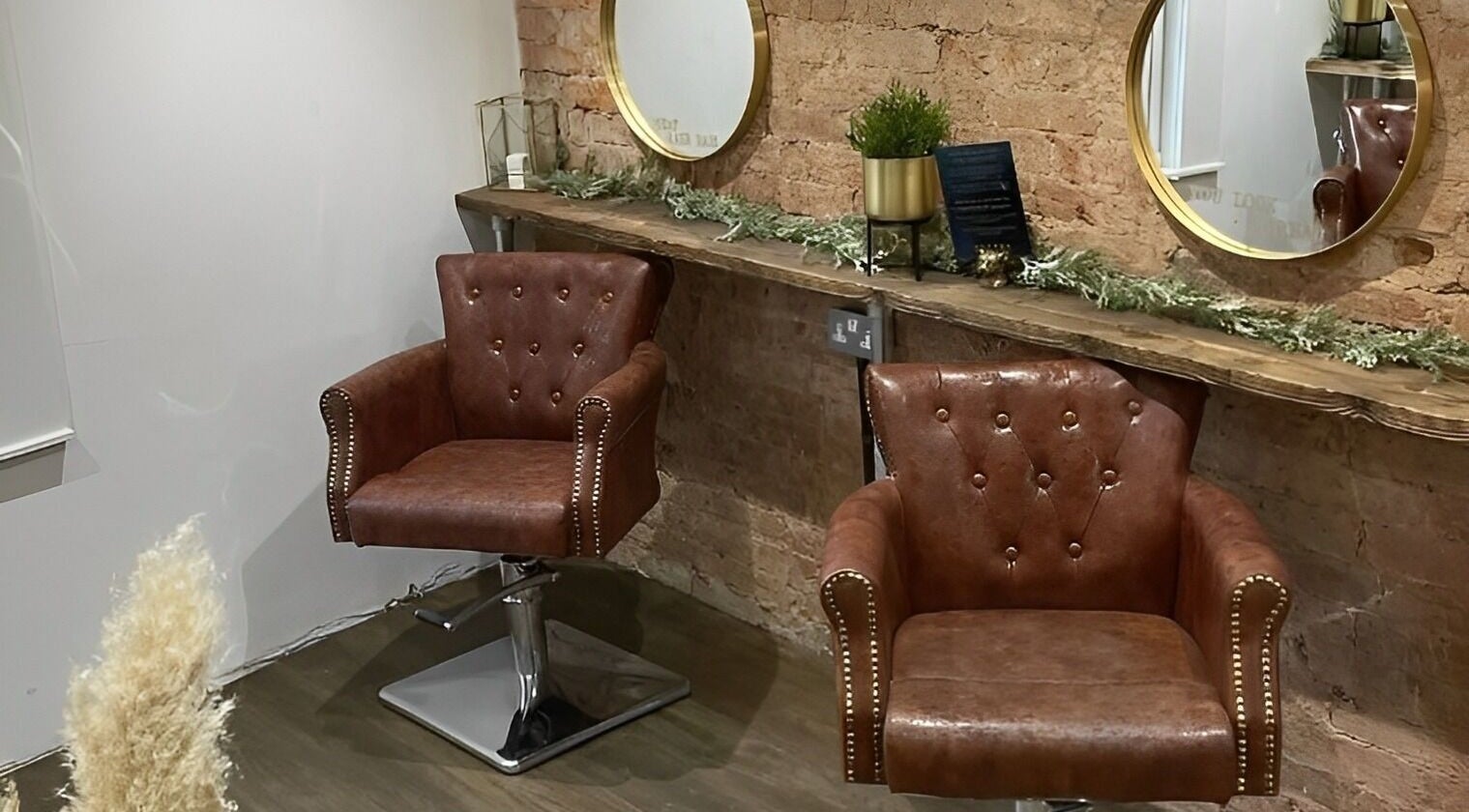 Elegant leather chairs at Salon Pickle in Bromsgrove, England, GB, offering a chic, vintage atmosphere.
