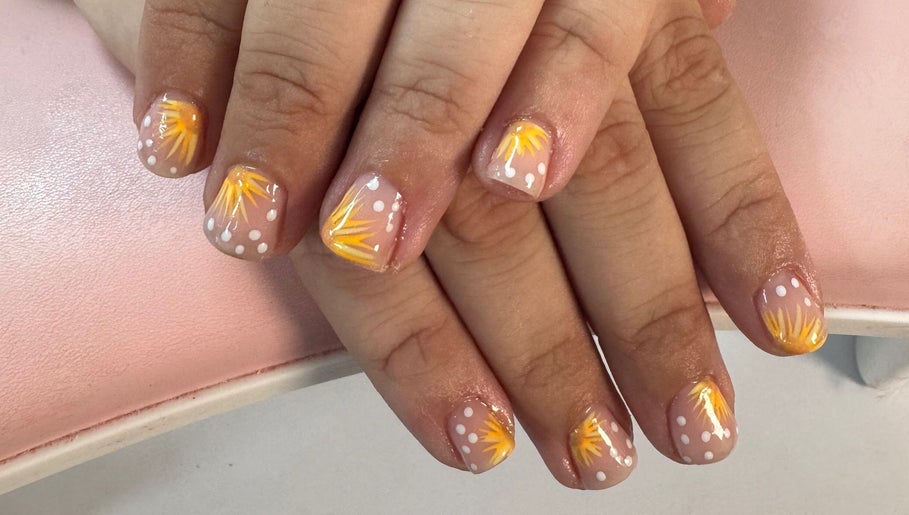 Vibrant nail art with yellow sunburst at Laura Kate Nails, Kidsgrove, England, GB.