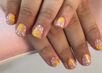 Vibrant nail art with yellow sunburst at Laura Kate Nails, Kidsgrove, England, GB.