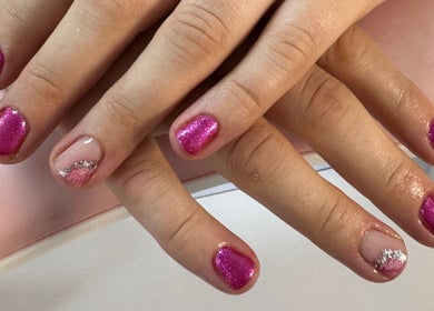 Bright pink glitter nails with silver accents at Laura Kate Nails, Kidsgrove, England, GB.