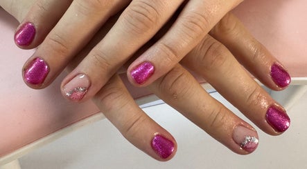Bright pink glitter nails with silver accents at Laura Kate Nails, Kidsgrove, England, GB.