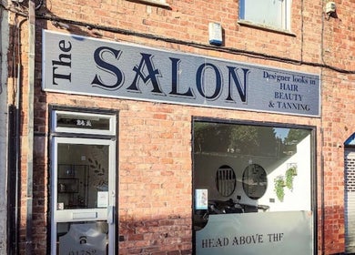 Entrance of Laura Kate Nails salon in Kidsgrove, England, GB, showcasing a stylish brick facade and signage.