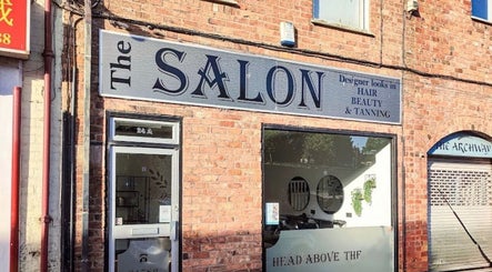 Entrance of Laura Kate Nails salon in Kidsgrove, England, GB, showcasing a stylish brick facade and signage.