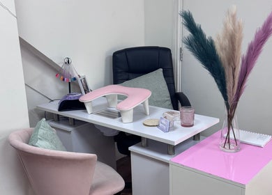 Stylish manicure station at Laura Kate Nails, Kidsgrove, England, GB with pink accents and comfortable seating.