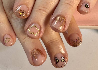 Gold and glitter nail art at Laura Kate Nails, Kidsgrove, England, GB showcasing intricate, chic designs.