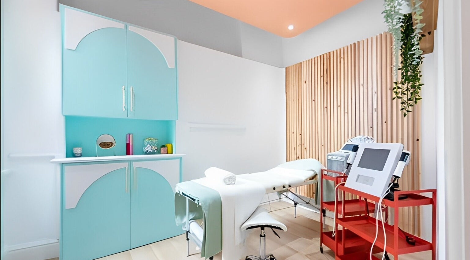 Bright spa treatment room at The Glow Up Social, Manchester, England, GB with modern decor and equipment.