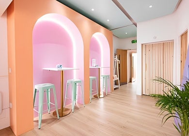 Bright and modern interior of The Glow Up Social in Manchester, England, GB with pastel tones and ambient lighting.
