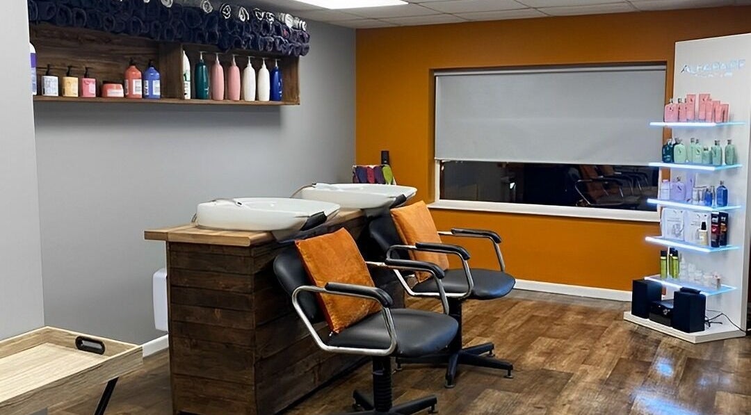 Modern salon wash area with orange accents at South Hair Boutique Dollingstown, Lurgan, Northern Ireland, GB.