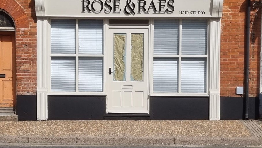 Front view of Kyle’s Cuts salon in Watton, England, GB with elegant brick and white exterior.