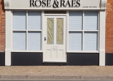 Front view of Kyle’s Cuts salon in Watton, England, GB with elegant brick and white exterior.