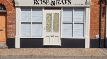 Front view of Kyle’s Cuts salon in Watton, England, GB with elegant brick and white exterior.