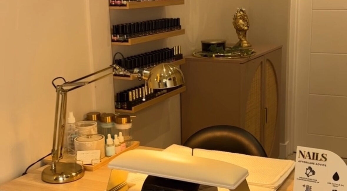 Nail salon station at Ellie Johnston Beauty, Oban, Scotland, GB with tools and products in a warm setting.