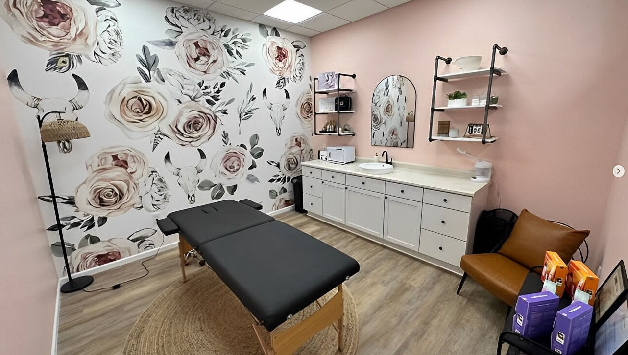 Chic treatment room at Beauty & Face Esthetics, Moline, Illinois, US with floral decor and stylish furniture.