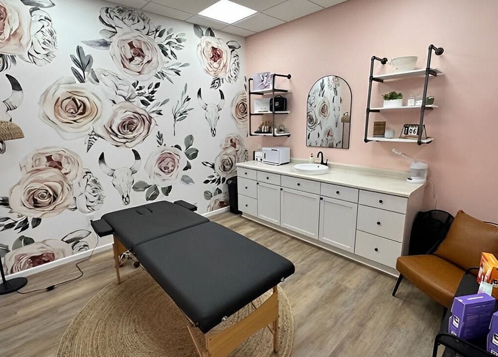 Chic treatment room at Beauty & Face Esthetics, Moline, Illinois, US with floral decor and stylish furniture.