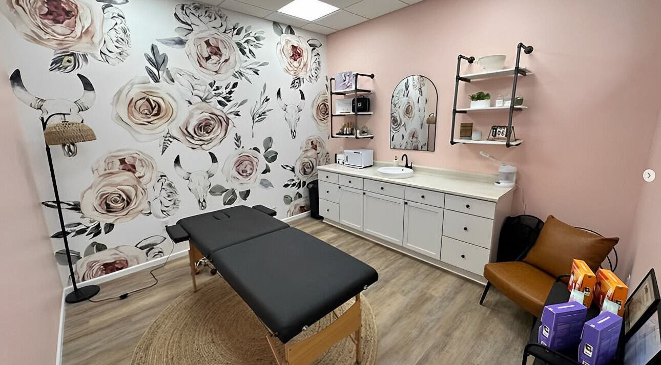 Chic treatment room at Beauty & Face Esthetics, Moline, Illinois, US with floral decor and stylish furniture.