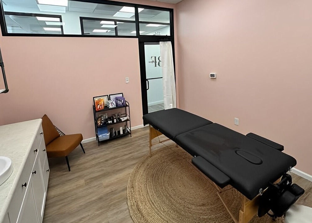 Peaceful treatment room at Beauty & Face Esthetics in Moline, Illinois, US with massage table and calming decor.