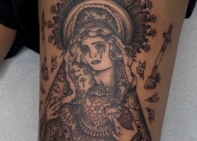 Intricate religious tattoo on arm at Ellipsis Tattoo Club, Paris, Île-de-France, FR. Detailed design with elaborate symbols.