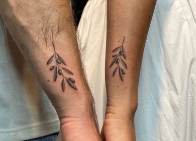Matching olive branch tattoos at Ellipsis Tattoo Club, Paris, Île-de-France, FR.