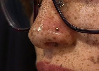 Elegant nose stud piercing at Ellipsis Tattoo Club in Paris, Île-de-France, FR showcasing expert craftsmanship.
