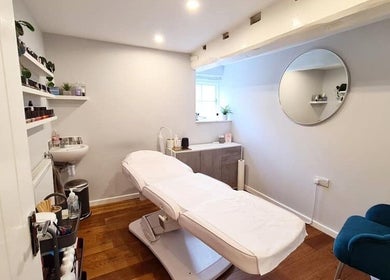 Relaxing spa treatment room at Rhiannon's Beauty Box, Long Melford, England, GB with a comfortable massage table.