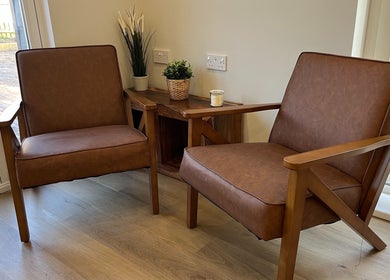 Comfortable brown chairs at Hidden Lane Hair, Winchburgh, Scotland, GB create a welcoming salon atmosphere.