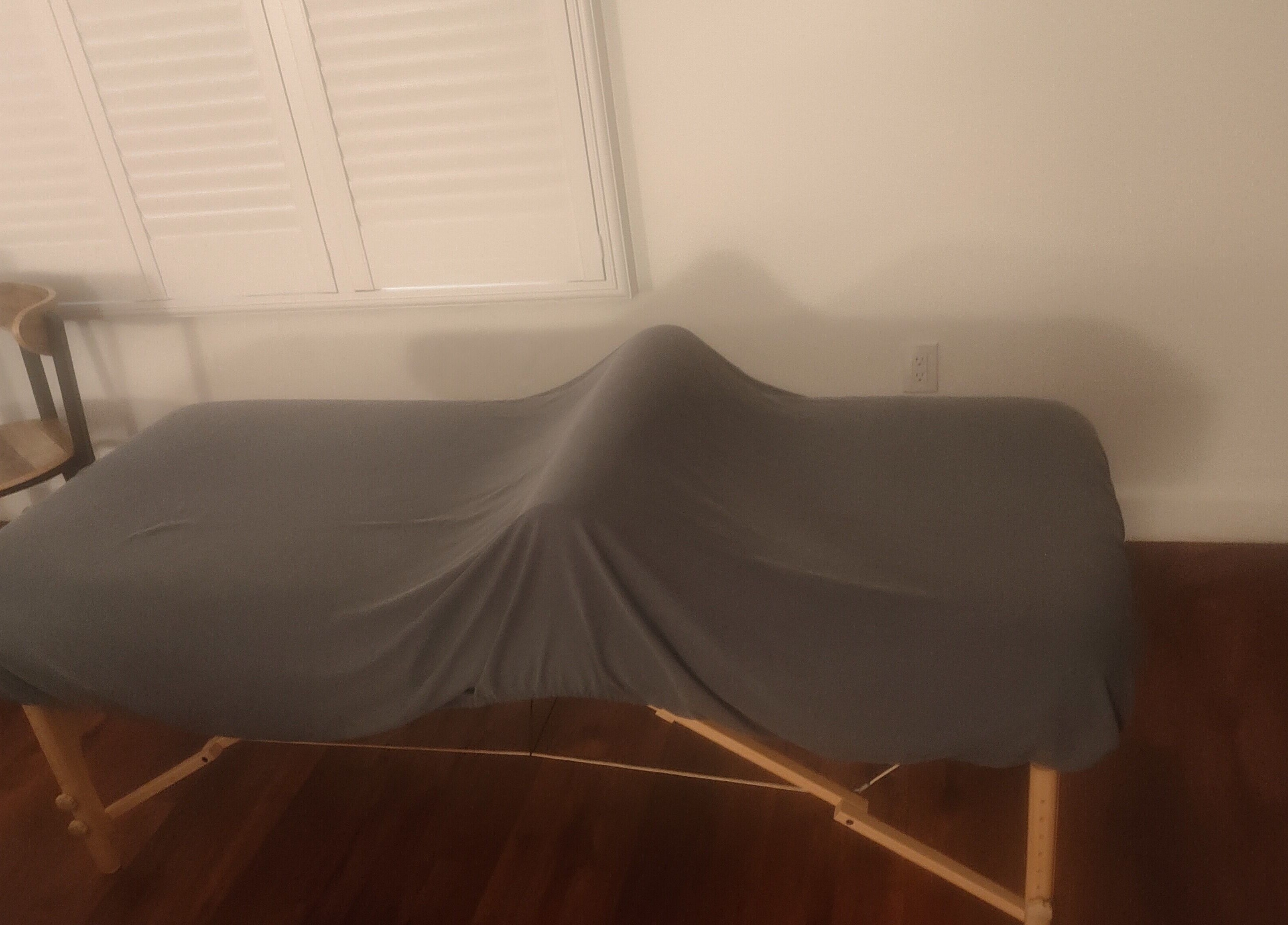 Massage table at Feel the Body Massage Therapy and Bodywork - Sacramento CA, enveloped in calming ambiance.