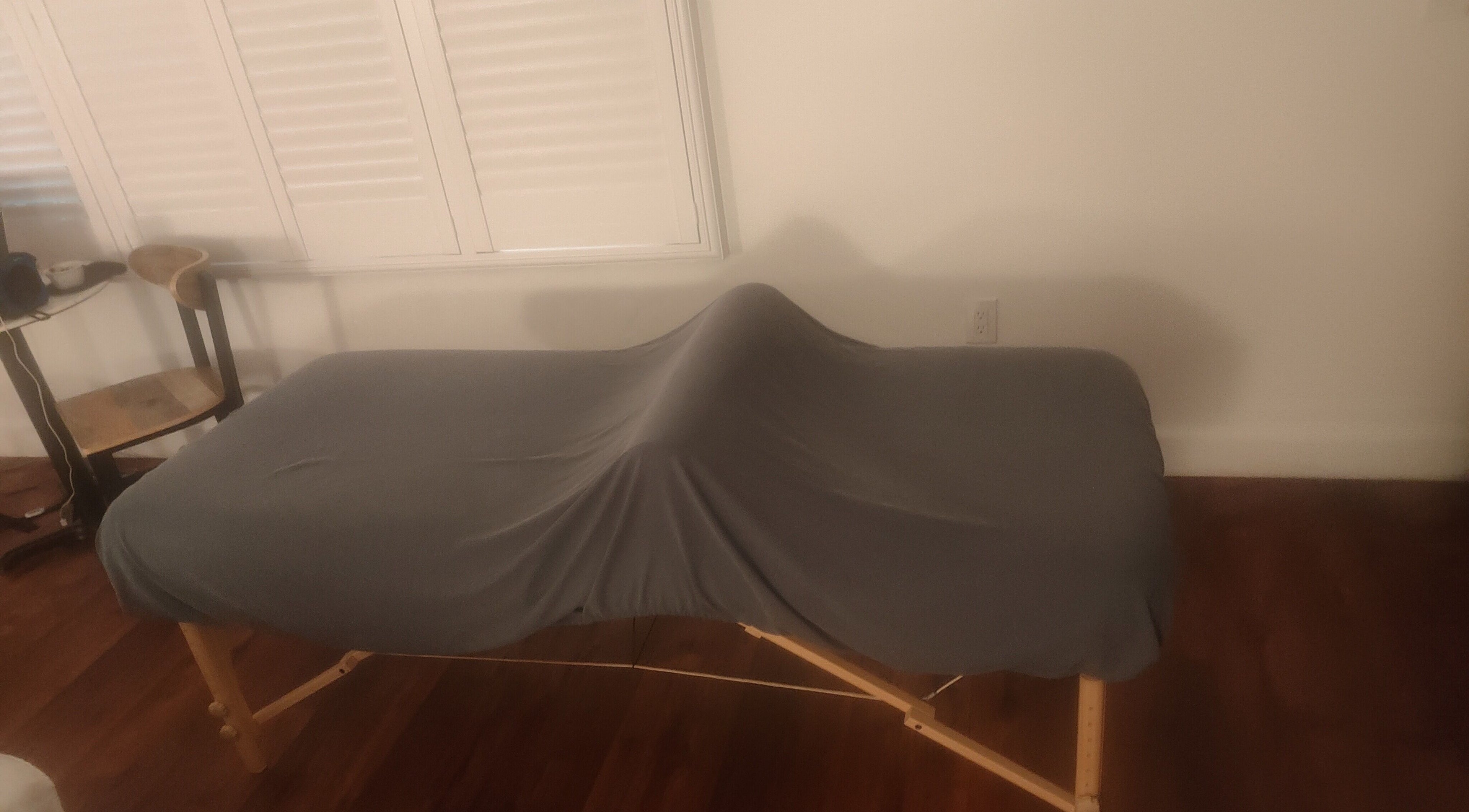 Massage table at Feel the Body Massage Therapy and Bodywork - Sacramento CA, enveloped in calming ambiance.