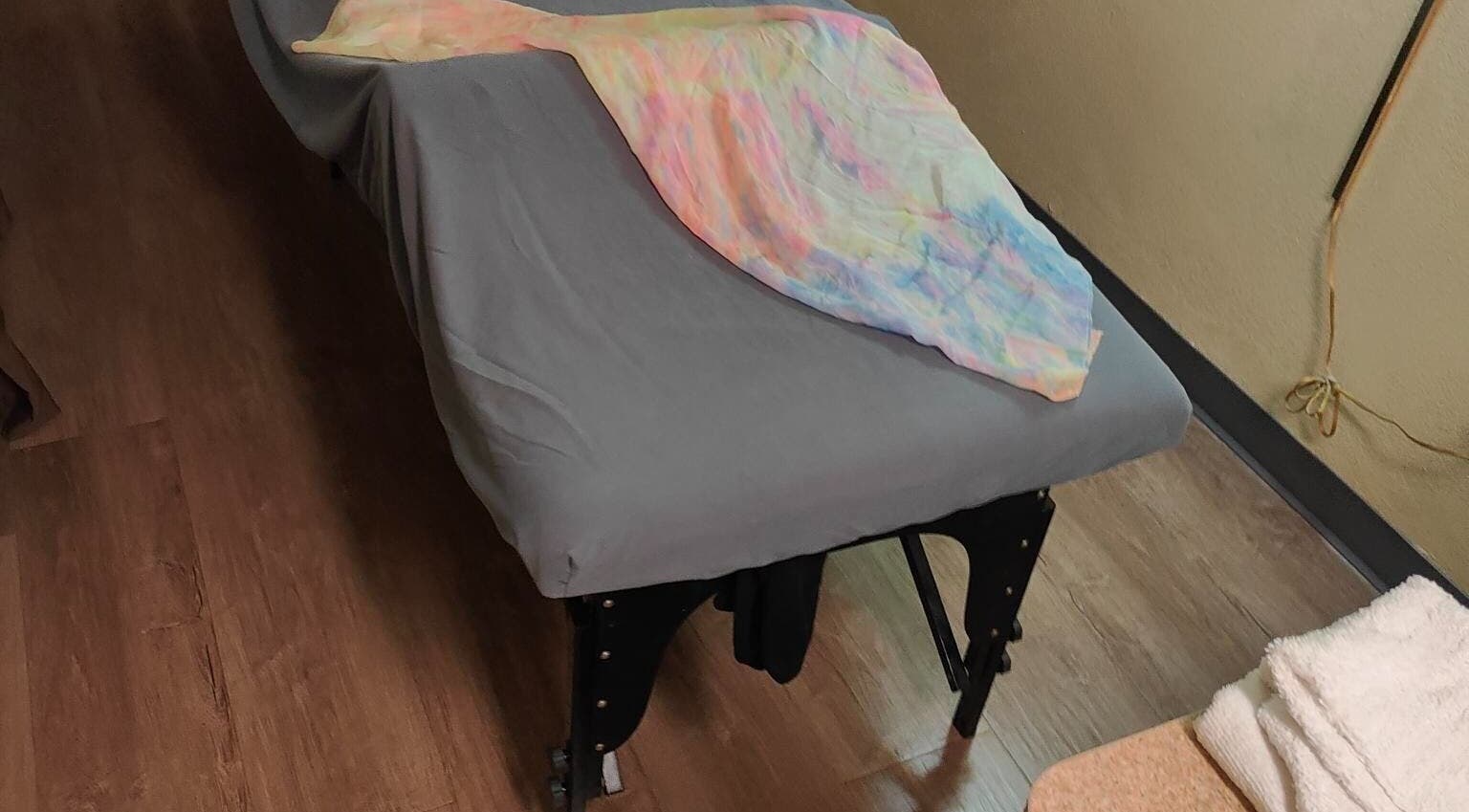 Cozy massage table with soft pastel sheet in Jacksonville FL spa, Jacksonville, Florida, US.