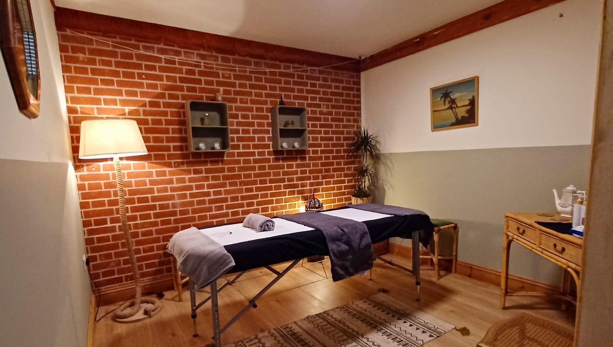 Relaxing therapy room at JC Remedial Therapy - @SunfyrBarns, Norwich, England, GB with massage table and soft lighting.