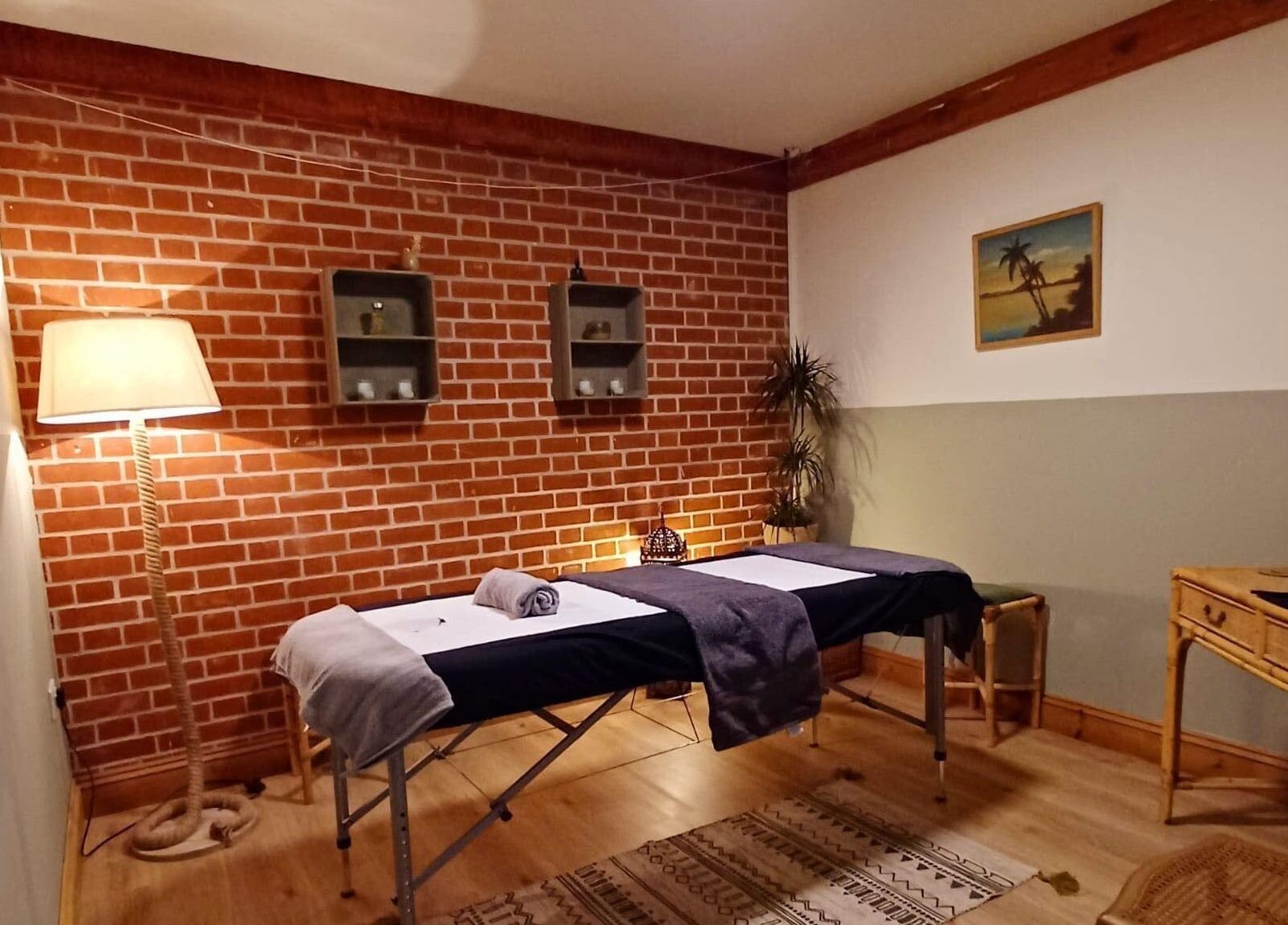 Relaxing therapy room at JC Remedial Therapy - @SunfyrBarns, Norwich, England, GB with massage table and soft lighting.