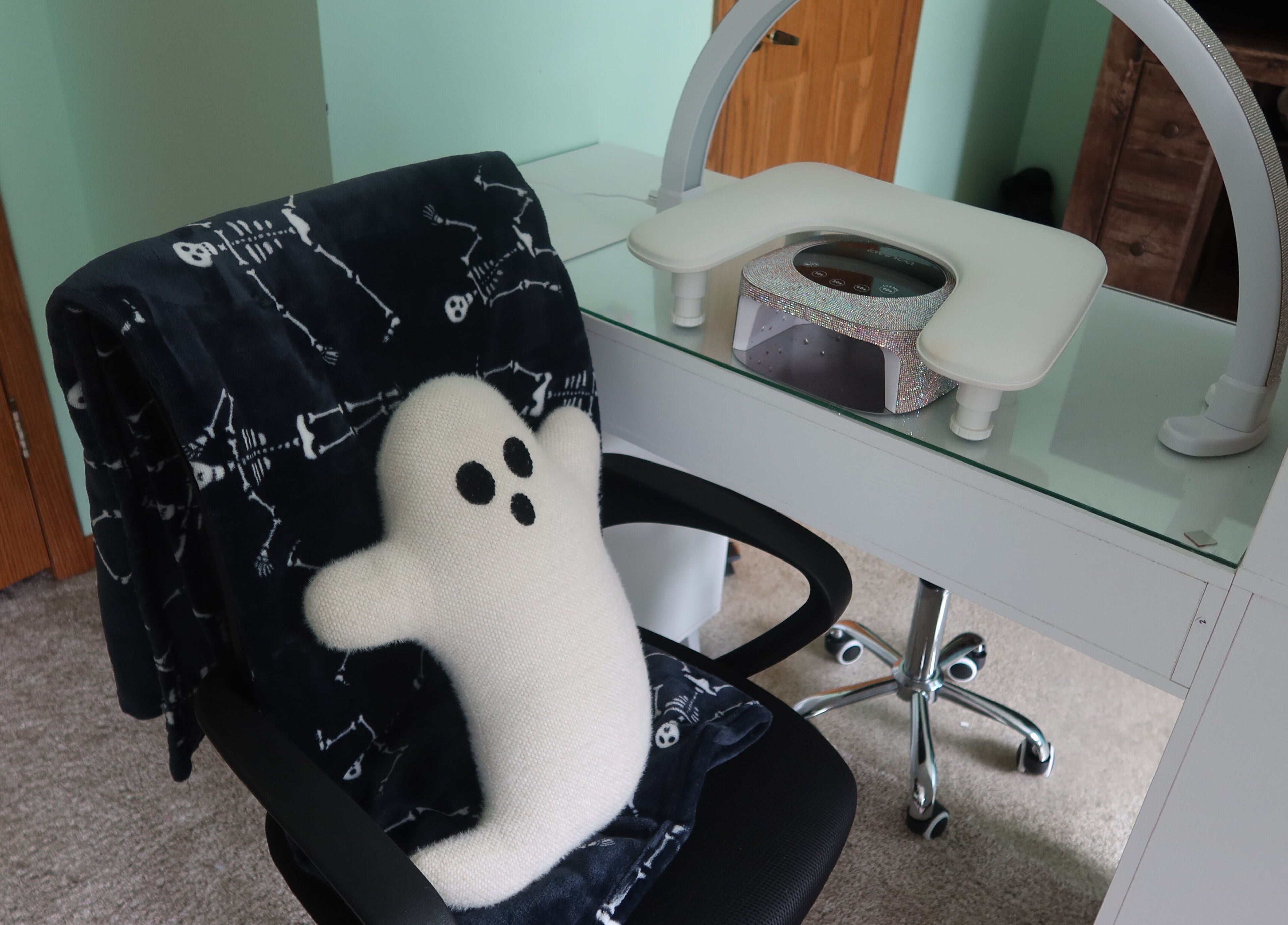 Cozy nail station at KD Designs, Lawrenceburg, Indiana, US with ghost pillow and comfy chair.