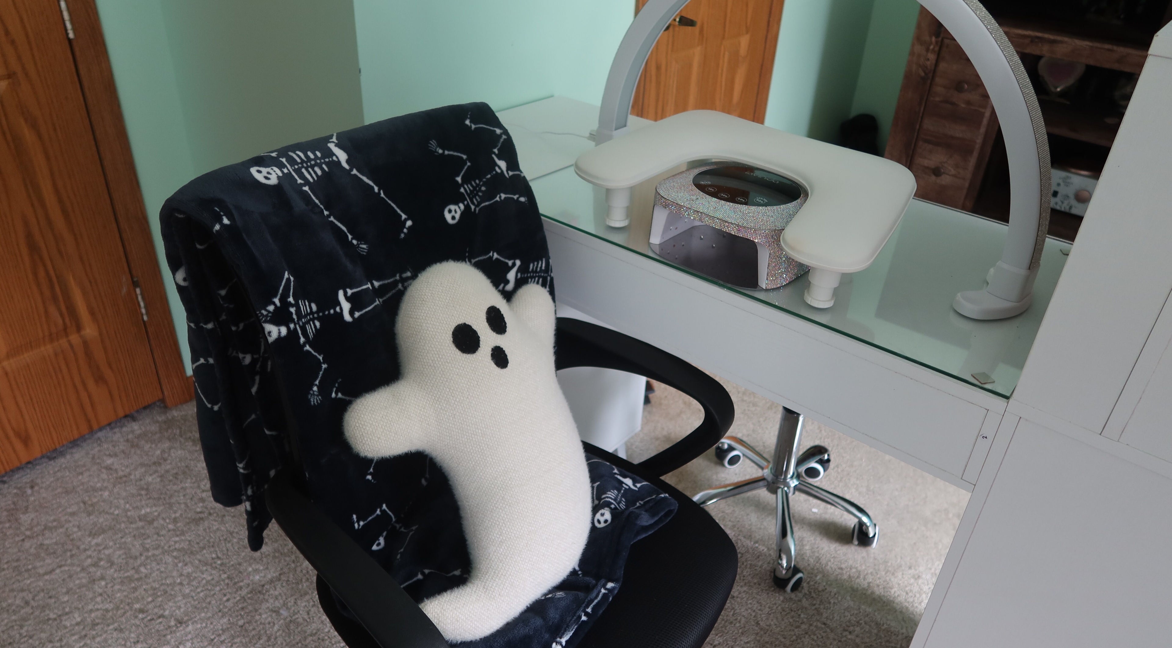 Cozy nail station at KD Designs, Lawrenceburg, Indiana, US with ghost pillow and comfy chair.