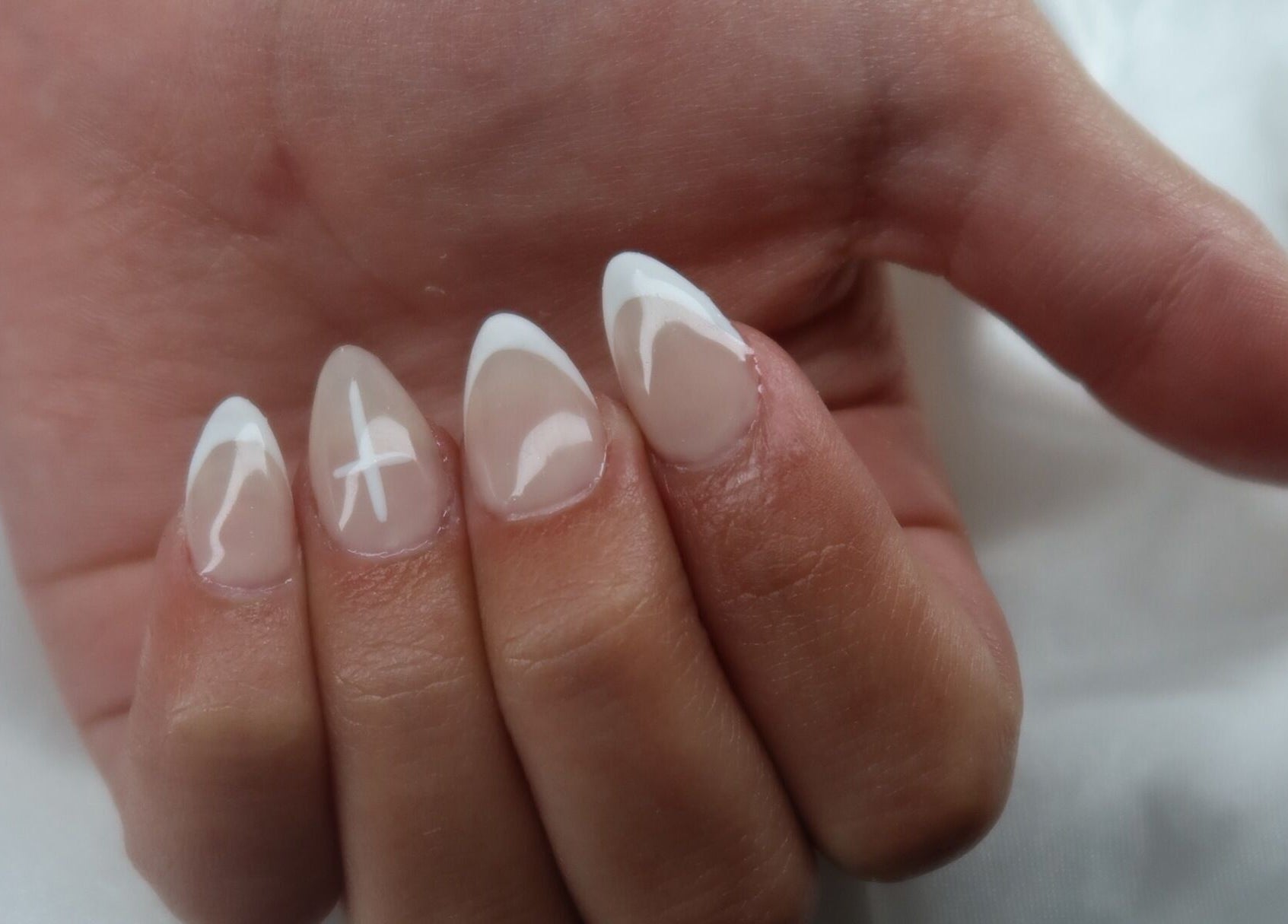 Elegant nail art at KD Designs in Lawrenceburg, Indiana. Stylish white and nude manicure on display.