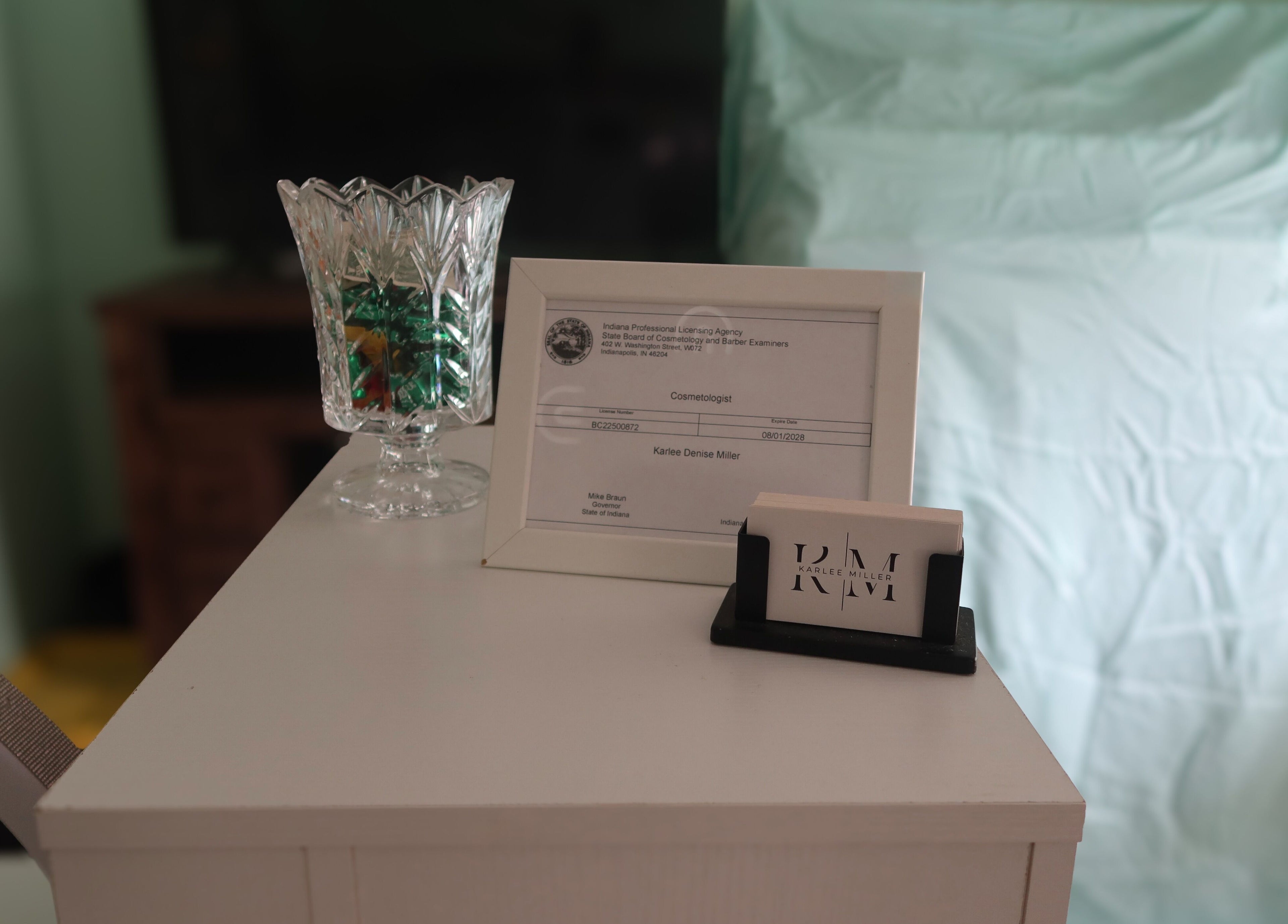 Framed certification and business cards at KD Designs, Lawrenceburg, Indiana, US, showcasing professionalism.
