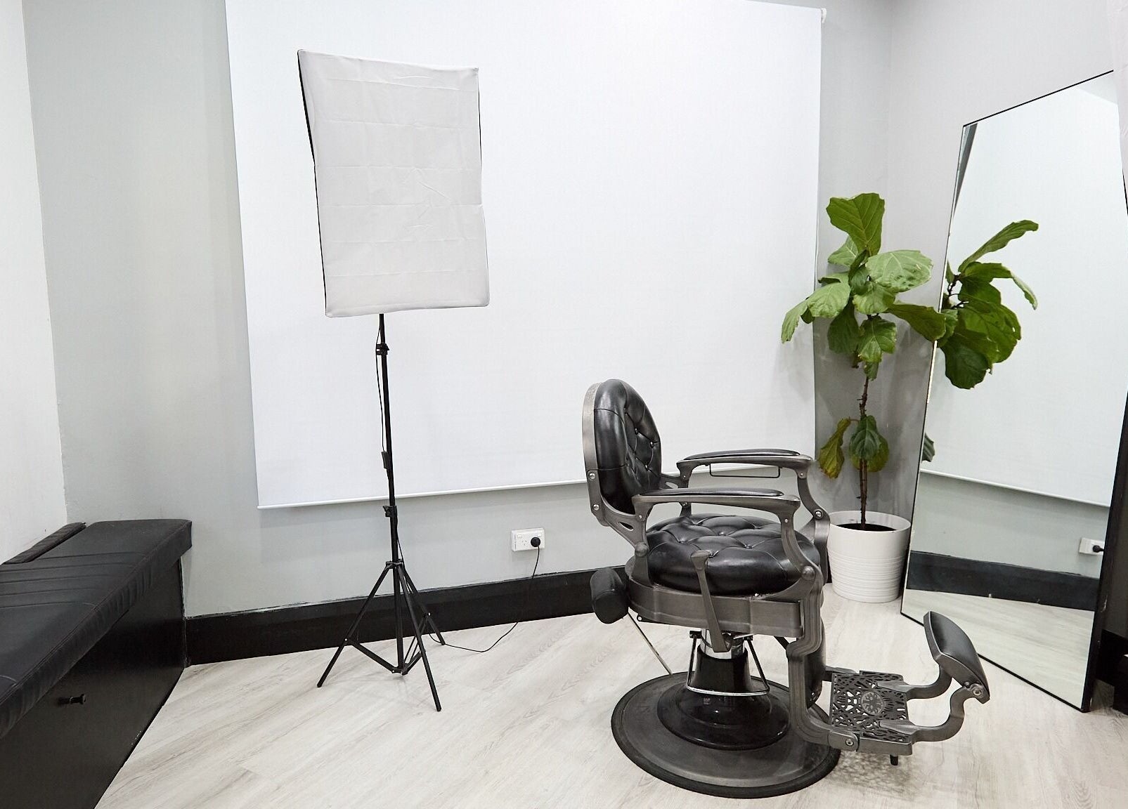 Modern interior of Lamanco Barbershop at Bondi Beach, NSW featuring sleek chair and plant decor.