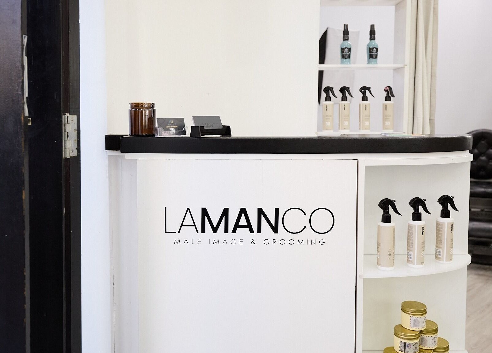 Modern reception at Lamanco Barbershop, Bondi Beach, New South Wales, AU, showcasing stylish grooming products.