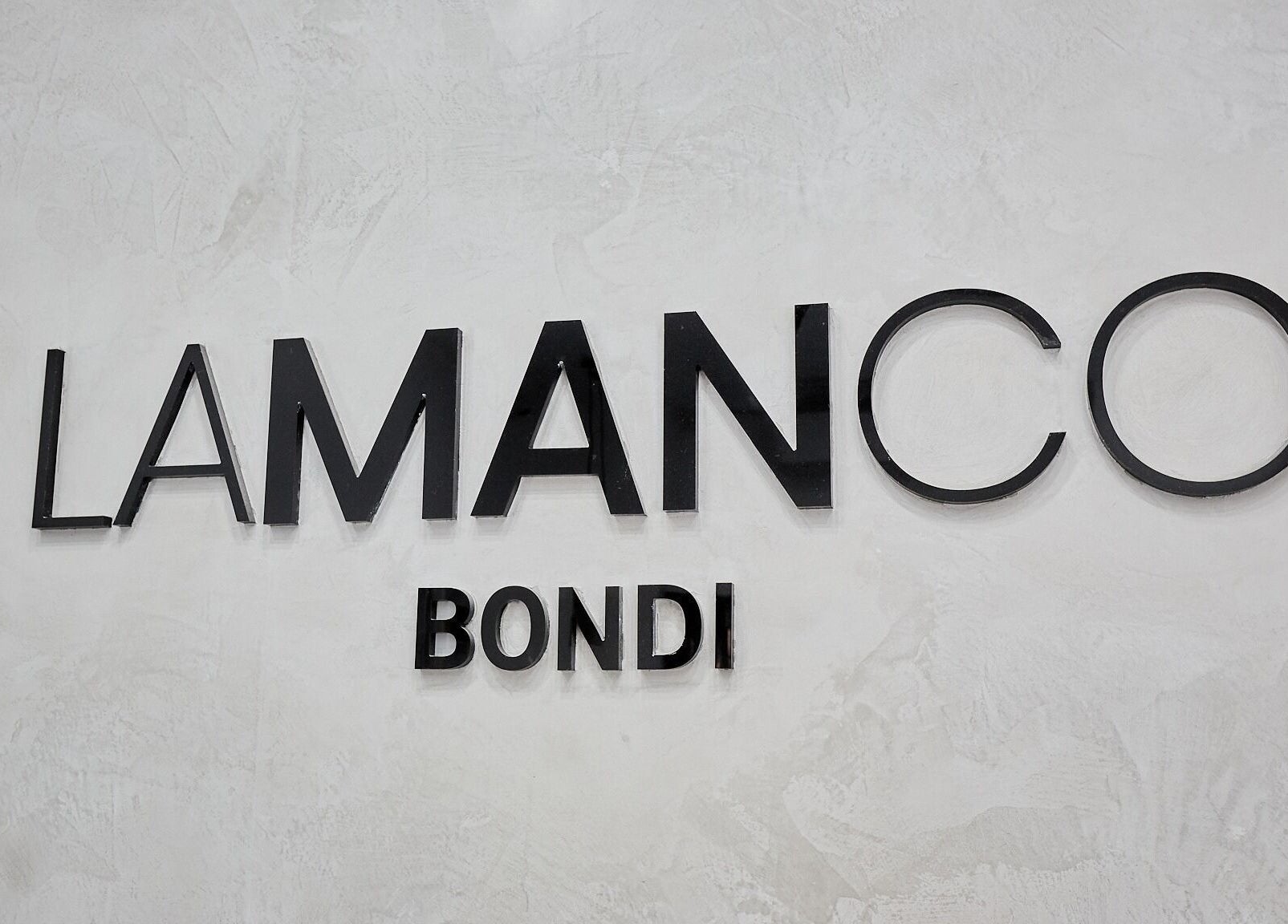 Elegant Lamanco Barbershop sign at Bondi Beach, New South Wales, AU, with a modern aesthetic.