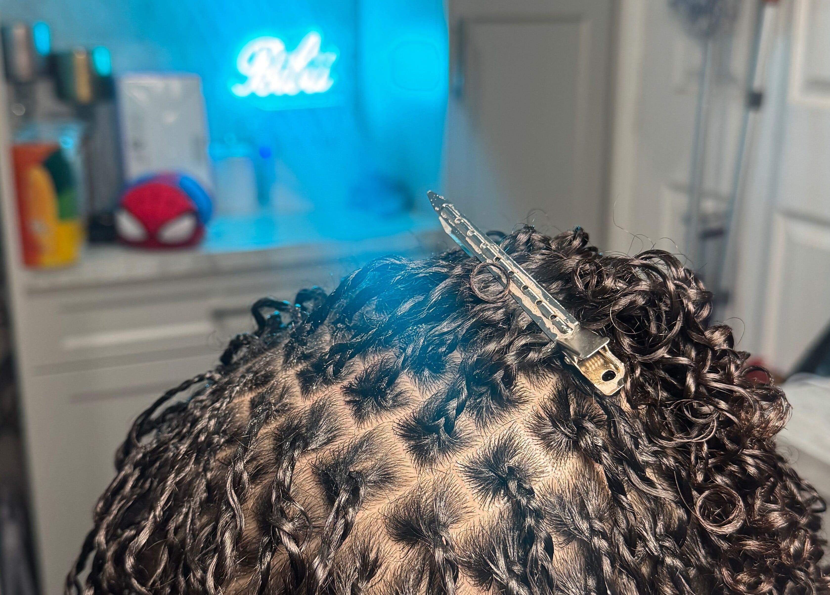 Close-up of intricate braided hairstyling at Bibii Hair, Miramar, Florida, US.