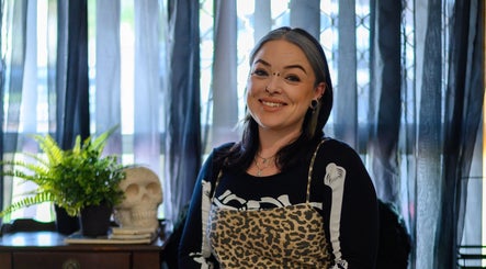 Smiling professional at Redemption Nails & Beauty in Narangba, Queensland, AU with stylish decor.