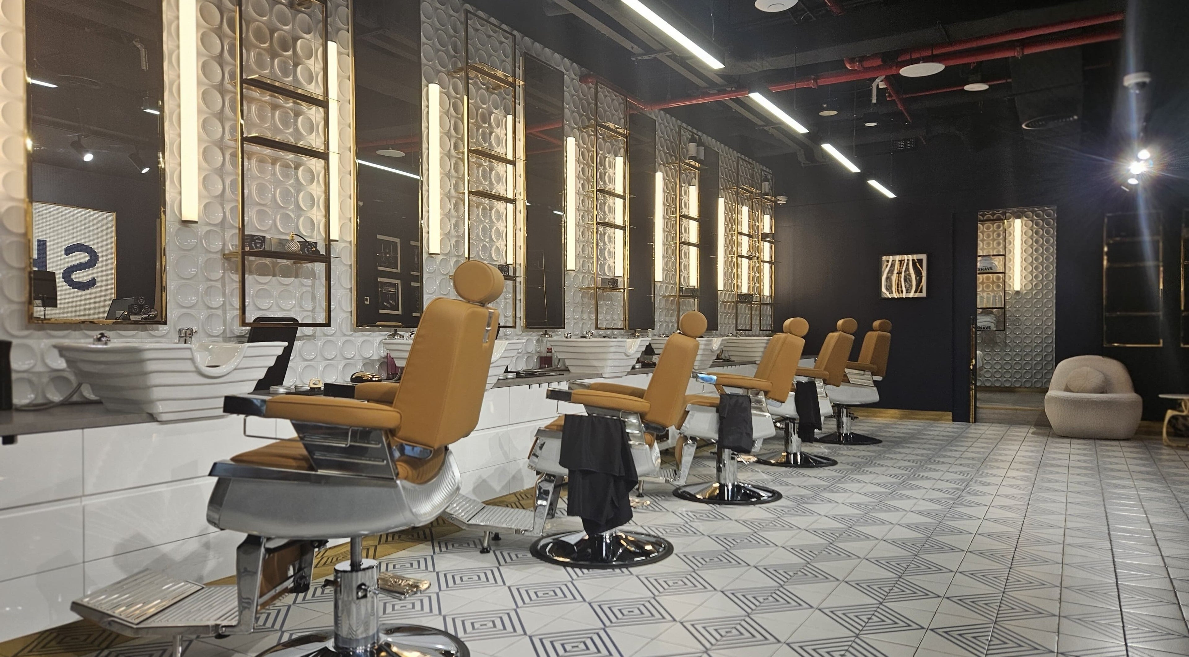 Sleek barber chairs at Shave Barbers & Spa - Hyde Hotel, Dubai, Dubai, AE, showcasing modern elegance.