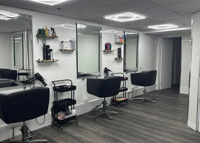 Modern salon setup at Cerys Dickson Hair at KM Hair Lounge in East Kilbride, Scotland, GB with sleek chairs and mirrors.