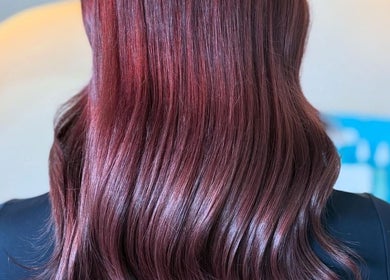 Glossy auburn hair styled at Cerys Dickson Hair at KM Hair Lounge in East Kilbride, Scotland, GB.