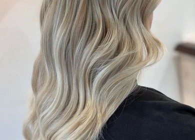 Elegant blonde waves styled at Cerys Dickson Hair at KM Hair Lounge, East Kilbride, Scotland, GB.