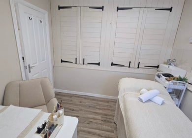 Cozy treatment room at Grove House Beauty, Misterton, England, GB with a massage bed and soothing decor.