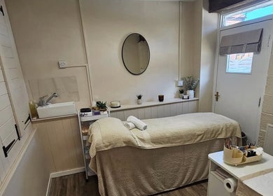 Serene treatment room at Grove House Beauty, Misterton, England, GB, with massage bed and soothing decor.