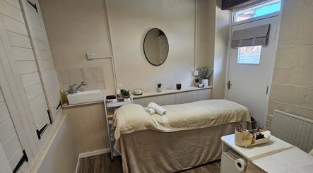 Serene treatment room at Grove House Beauty, Misterton, England, GB, with massage bed and soothing decor.